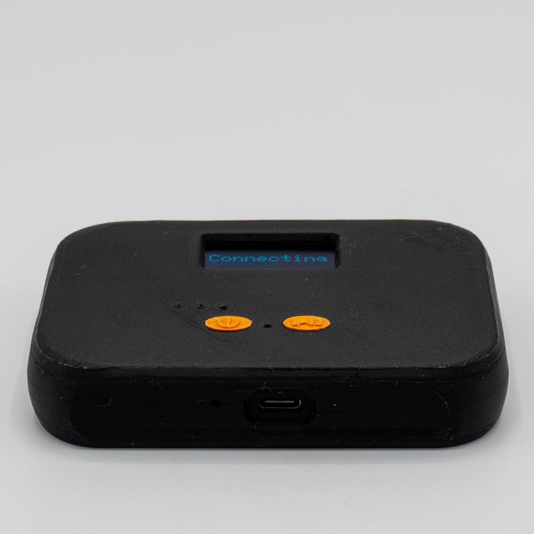 The QuickComm Table Top seen from its front edge, USB-C port below the lit status display